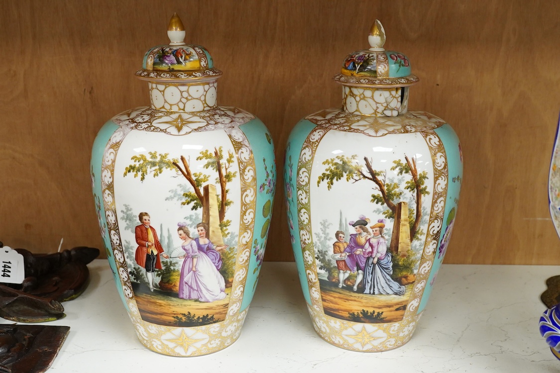 A pair of late 19th century Dresden vases and covers decorated by Helena Wolfsohn, one with damage, 34cm high
